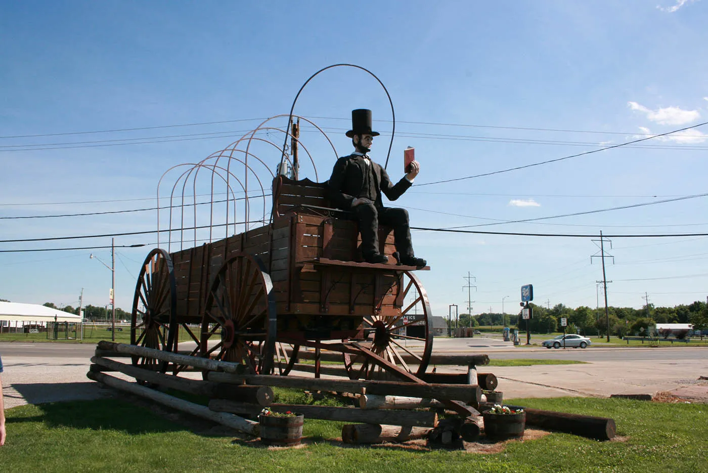 Best Illinois roadside attractions: Lincoln on the World's Largest Covered Wagon in Lincoln, Illinois. Visit this roadside attraction on an Illinois road trip with kids or weekend getaway with friends. Add the world's largest Covered Wagon to your road trip bucket list and visit them on your next travel adventure.