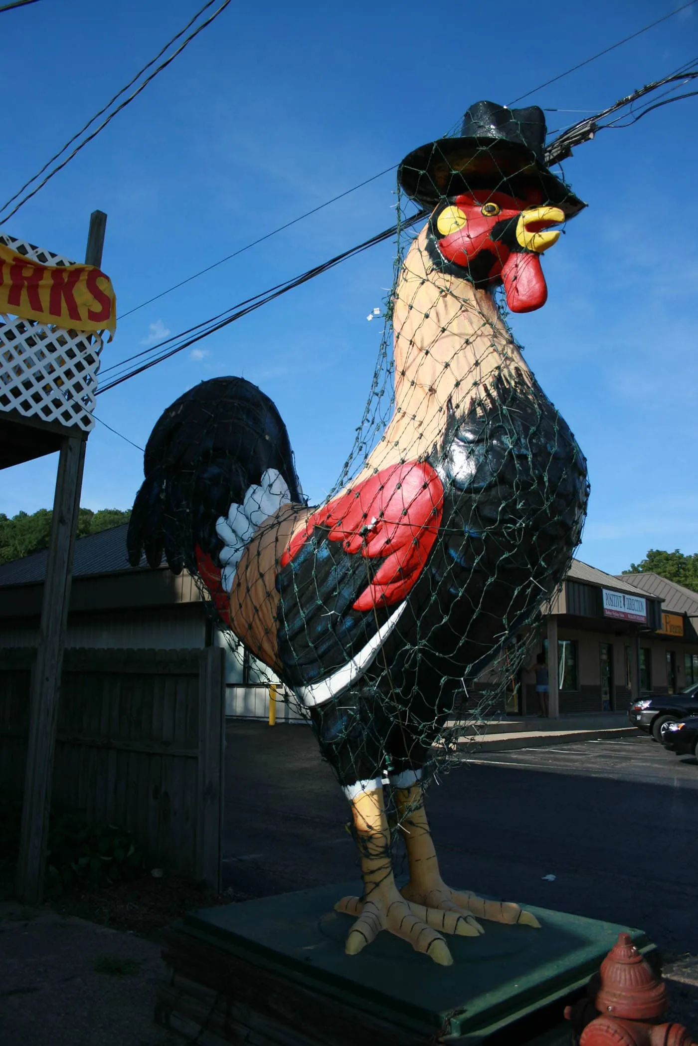 Giant Rooster in a top hat roadside attraction is a ten-foot tall statue that stands outside of Carl's Bakery in East Peoria, Illinois.