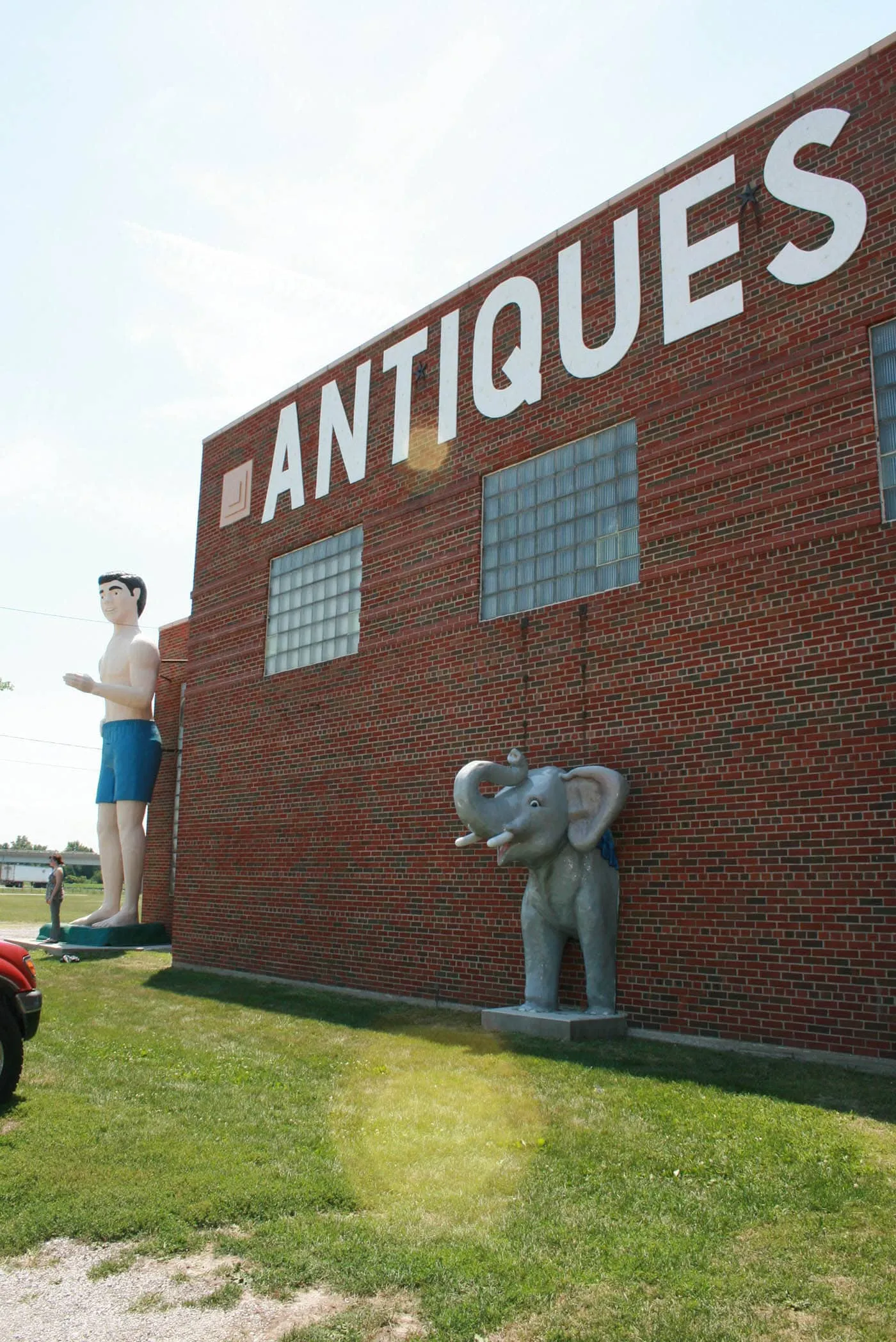 Giant Beach Guy and fiberglass elephant  - roadside attractions at Pink Elephant Antique Mall in Livingston, Illinois