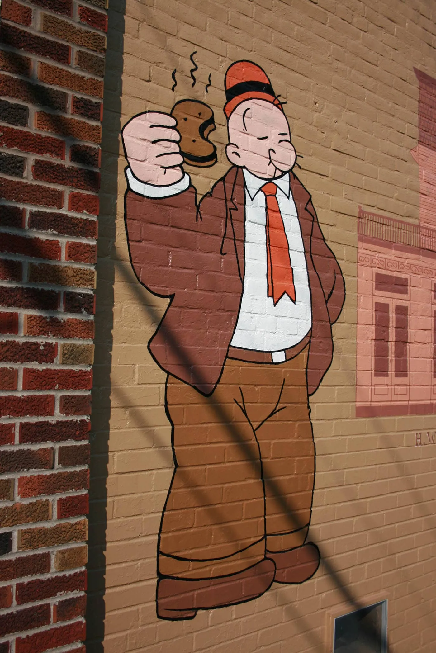 Popeye Mural in Chester, Illinois shows Wimpy eating a hamburger