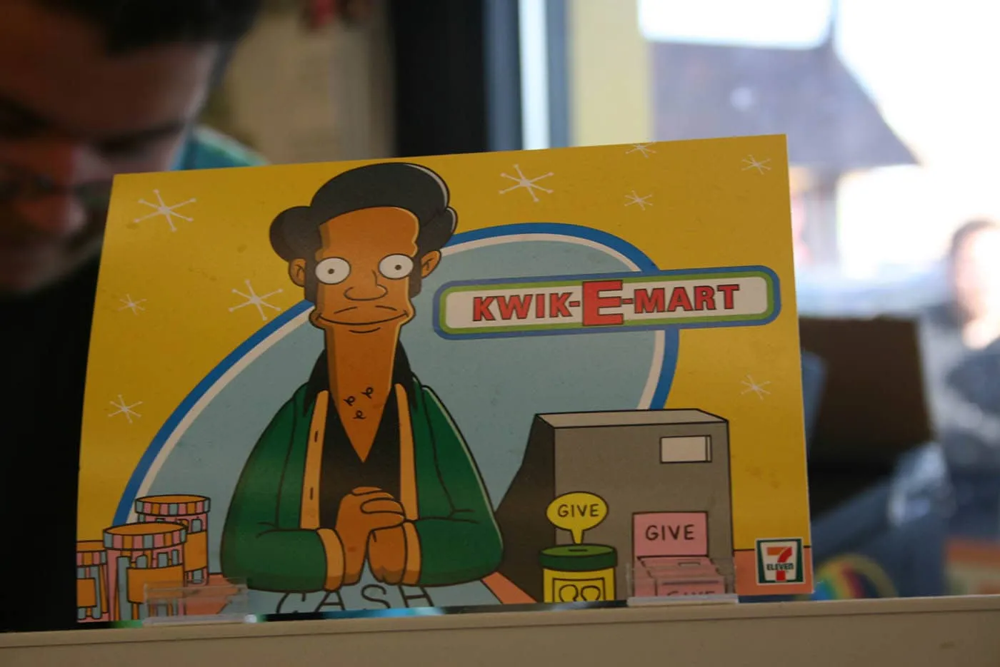Apu at the register at The Simpsons 7-Eleven Kwik-E-Mart in Chicago, Illinois