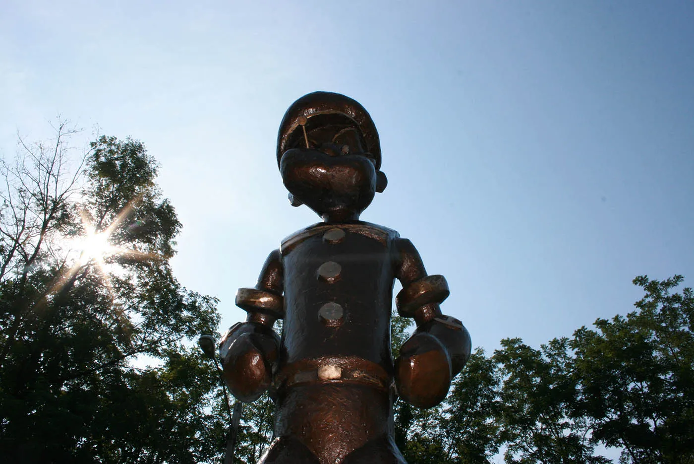 Best Illinois roadside attractions: Popeye statue in Chester, Illinois, the Home of Popeye the Sailor Man. Visit this roadside attraction on an Illinois road trip with kids or weekend getaway with friends. Add the Popeye statue to your road trip bucket list and visit them on your next travel adventure.