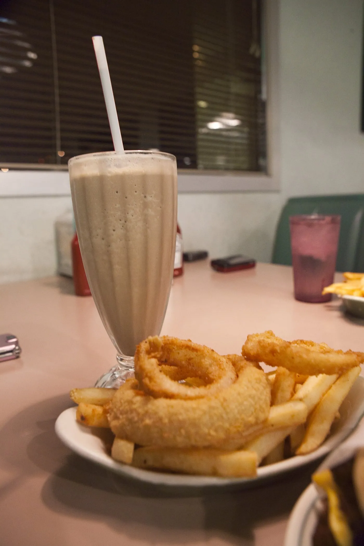 A 50/50 of fries and onion rings, and a chocolate milkshake at Winstead's in Overland Park, Kansas.