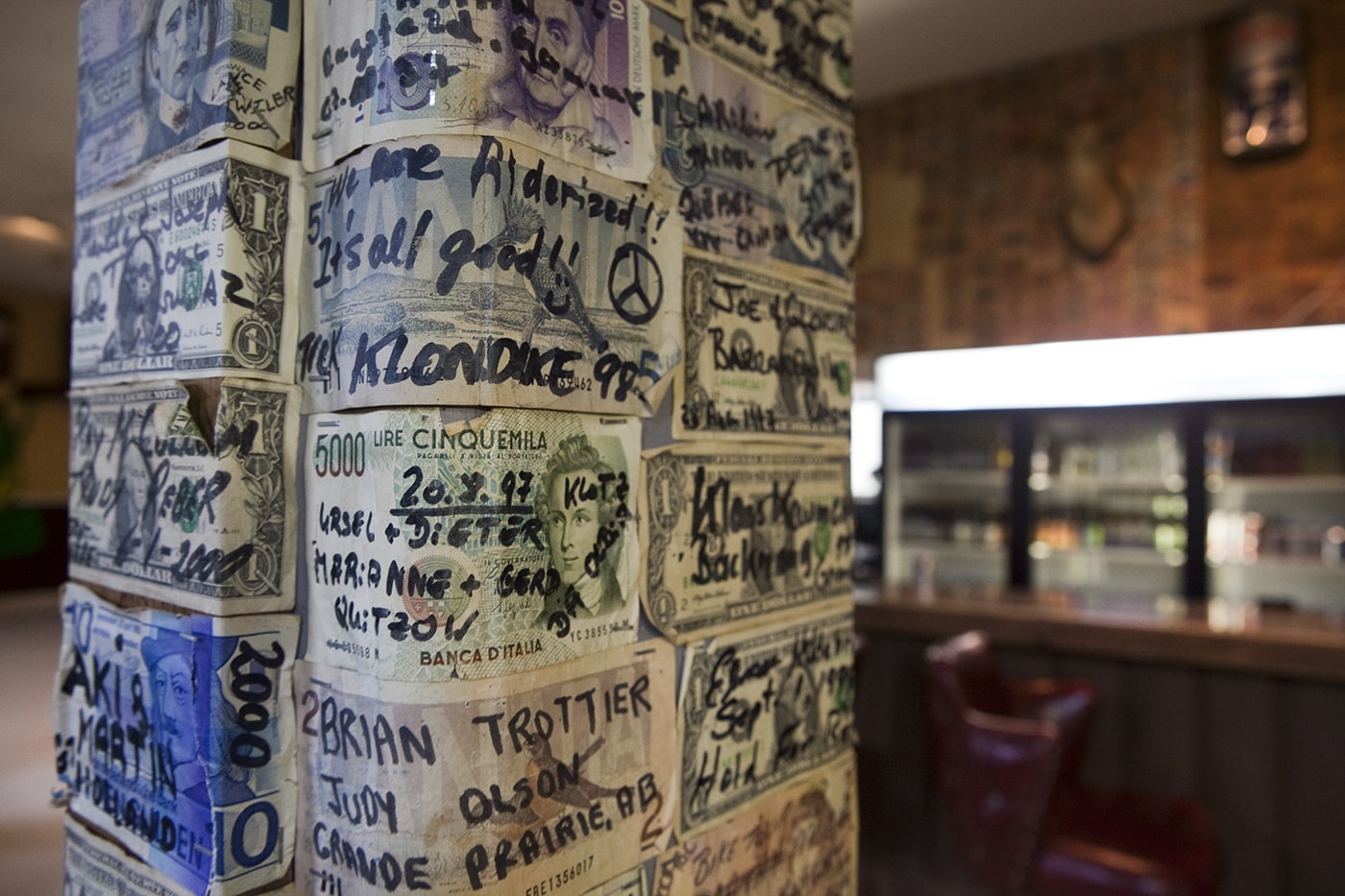 Signed dollars from all over the world line the walls of the Glacier Inn in Hyder, Alaska.