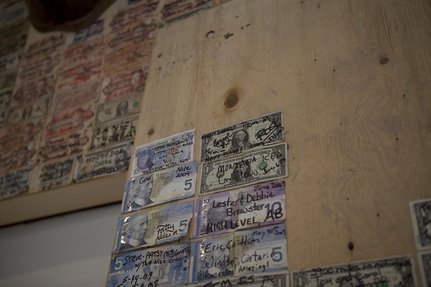 Signed dollars from all over the world on the wall of the Glacier Inn in Hyder, Alaska.