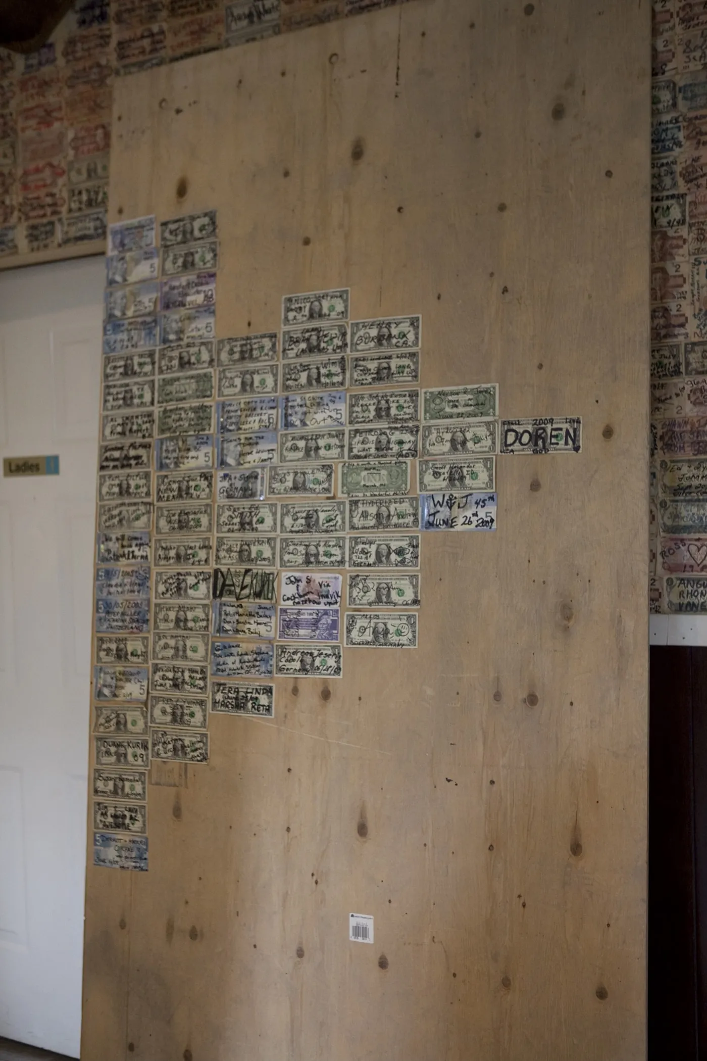 Signed dollars from all over the world on the wall of the Glacier Inn in Hyder, Alaska.