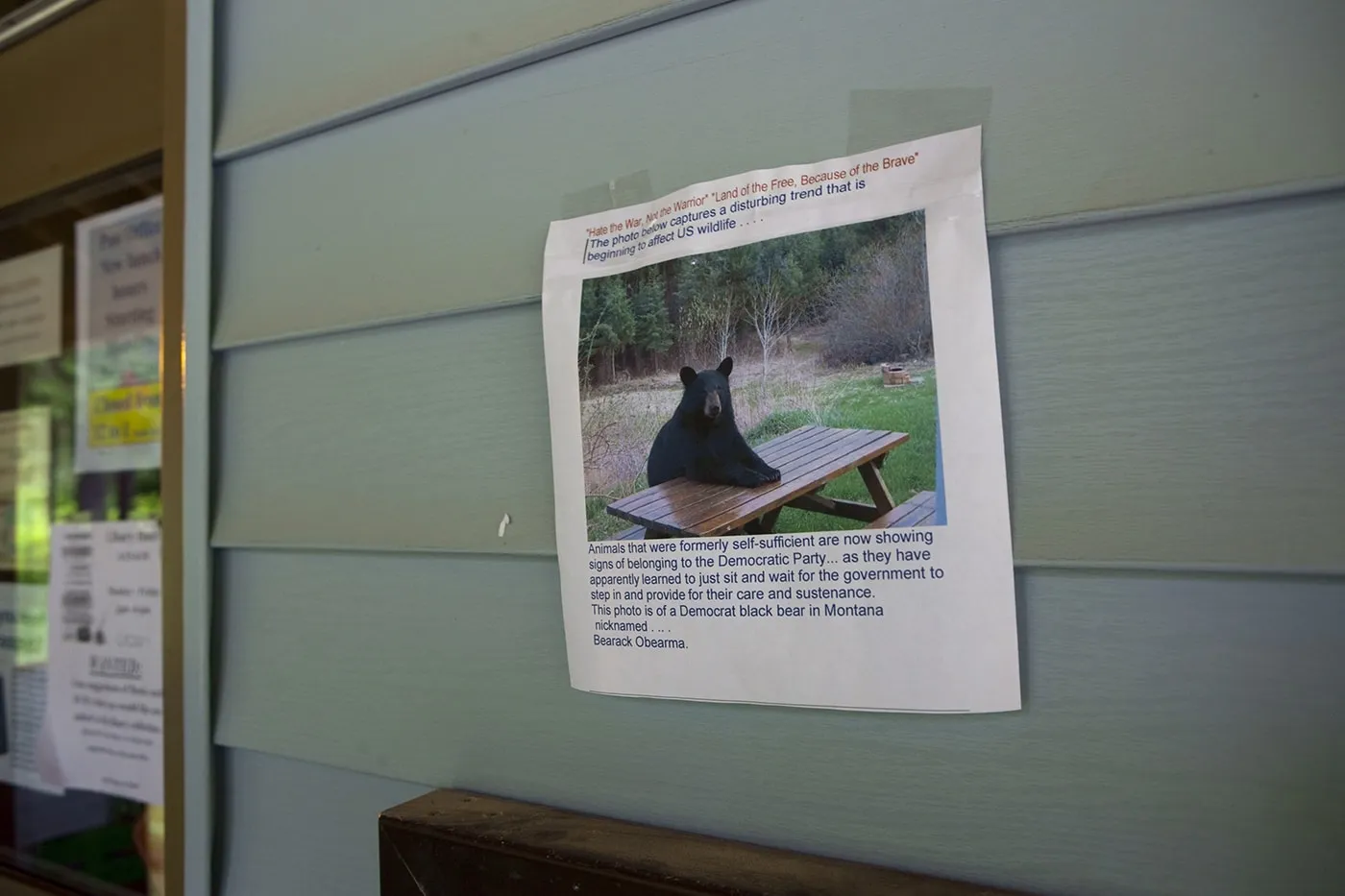 Bear at a picnic table sign at the Hyder, Alaska Post Office.