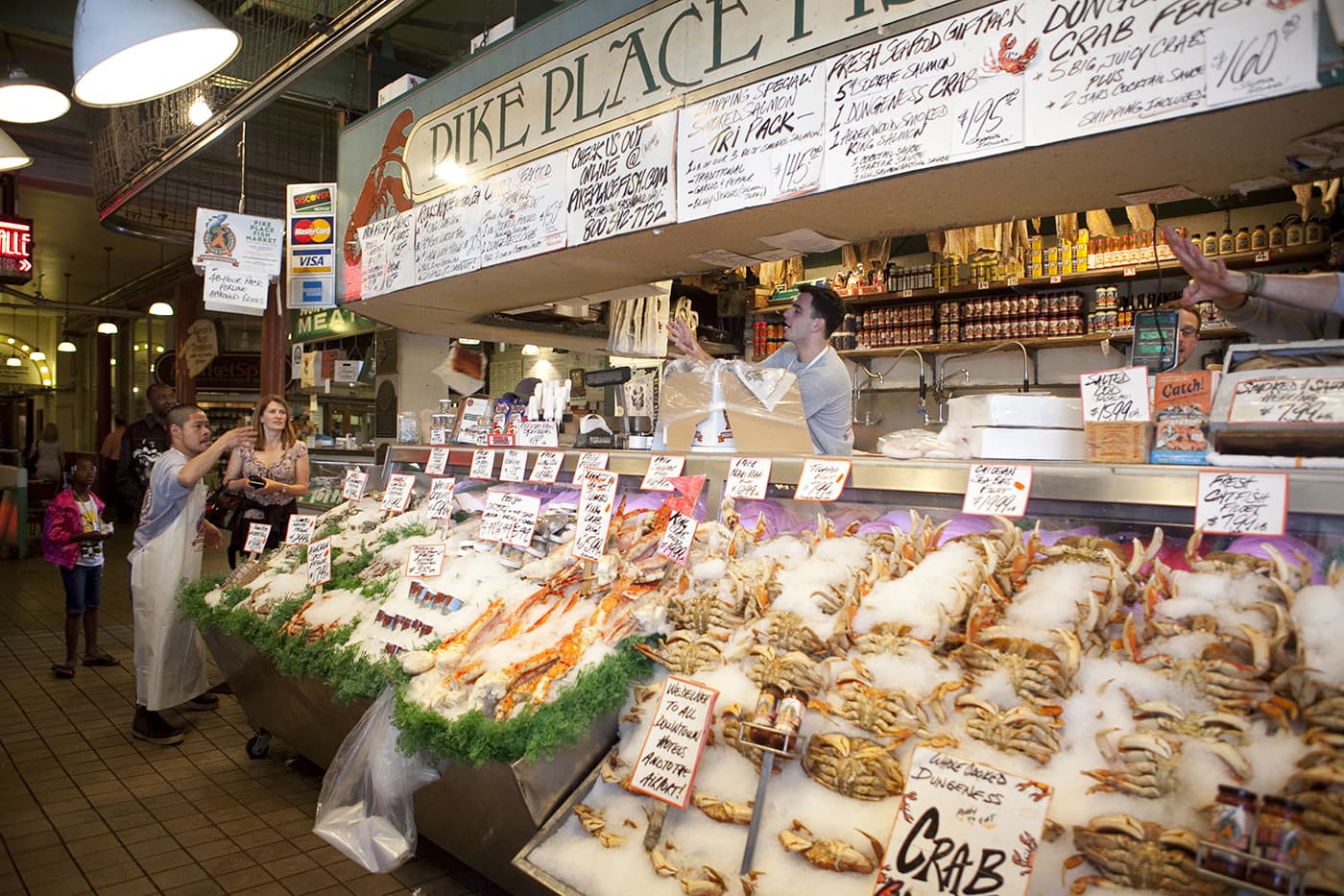 Fishmongers throwing fish at Pike Place Fish Market in Seattle, Washington.