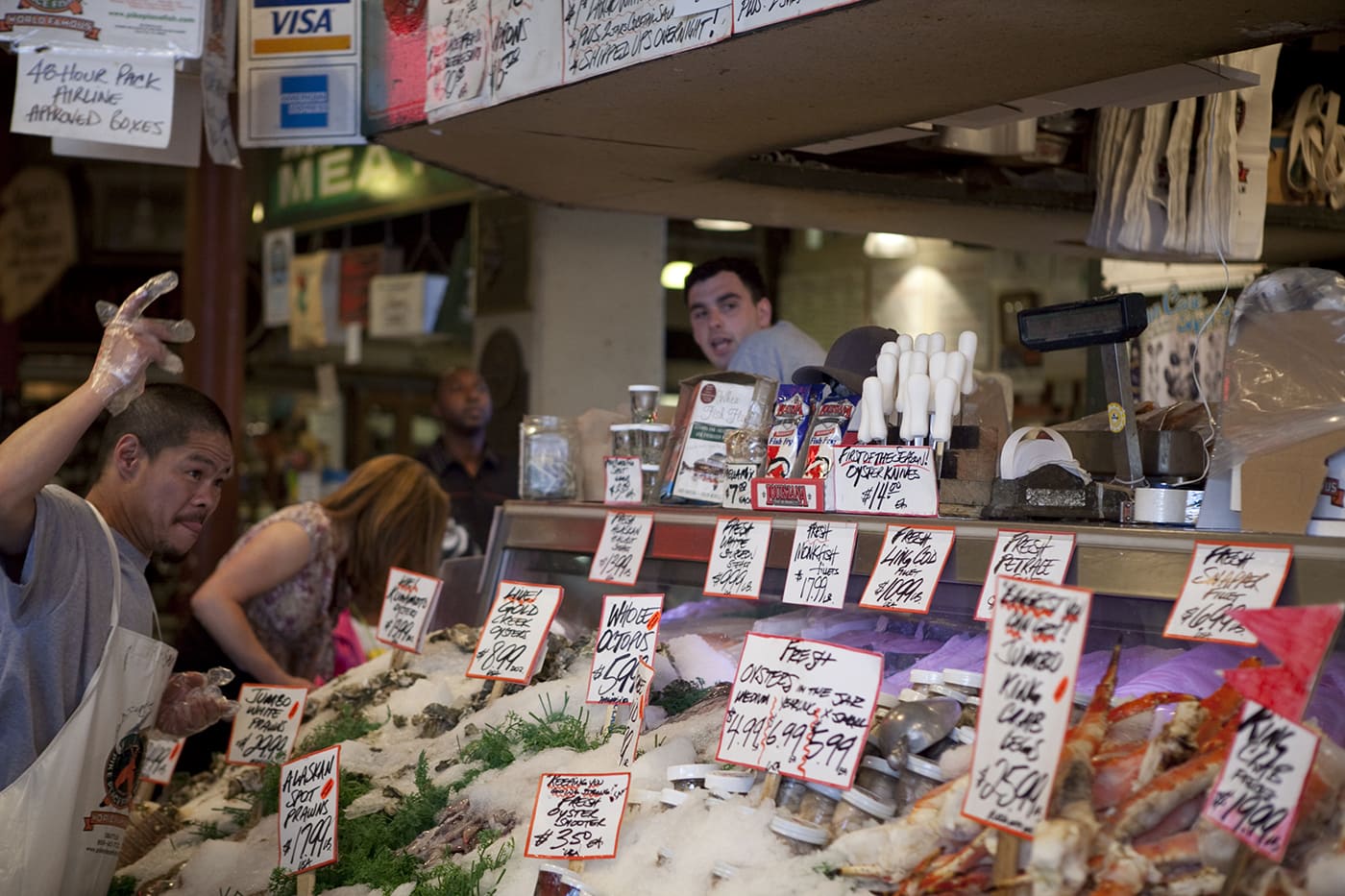 Fishmongers throwing fish at Pike Place Fish Market in Seattle, Washington.