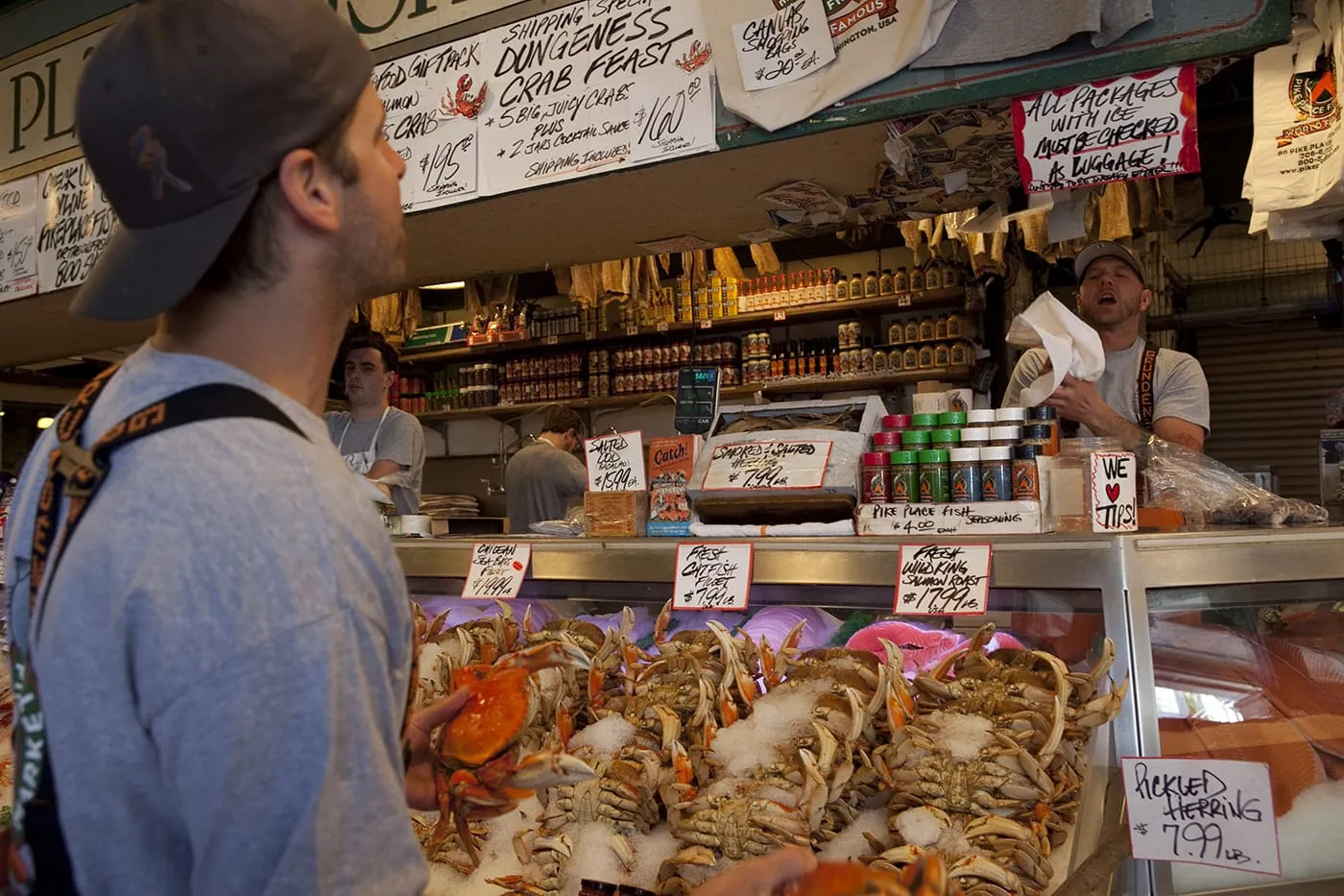 Fishmongers throwing fish at Pike Place Fish Market in Seattle, Washington.