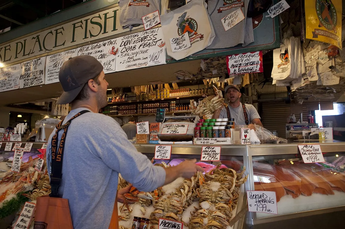 Fishmongers throwing fish at Pike Place Fish Market in Seattle, Washington.