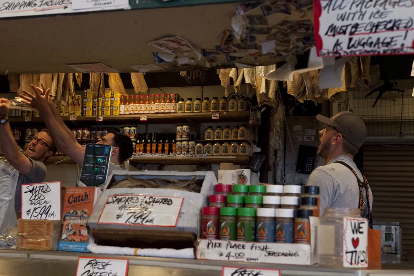 Fishmongers throwing fish at Pike Place Fish Market in Seattle, Washington.