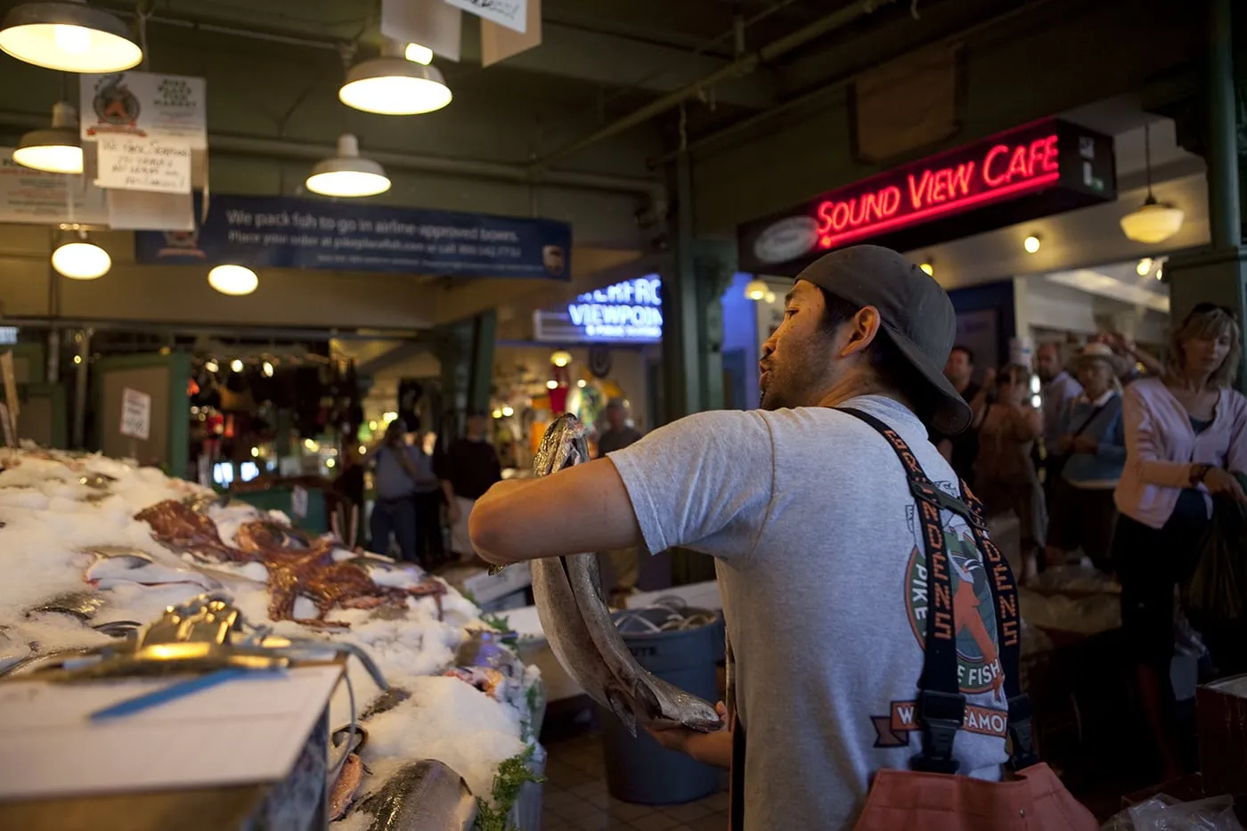 Fishmongers throwing fish at Pike Place Fish Market in Seattle, Washington.