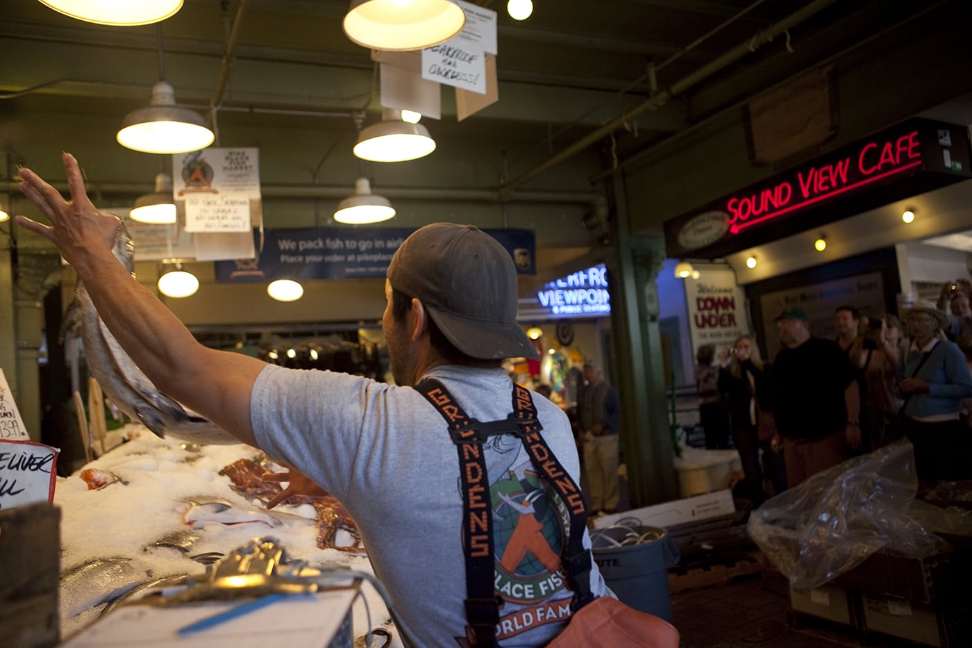 Fishmongers throwing fish at Pike Place Fish Market in Seattle, Washington.