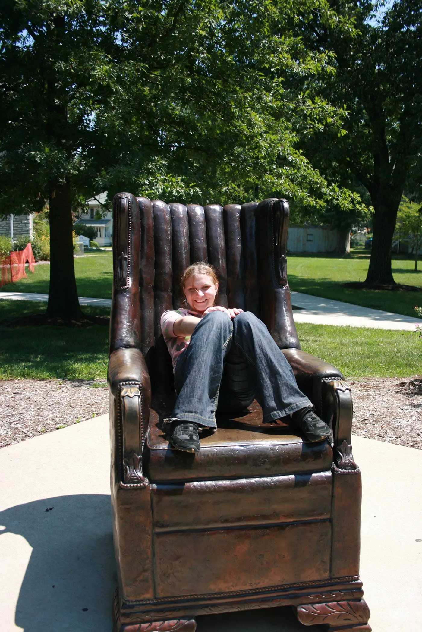 Val sits on the replica of Robert Wadlow's chair in Alton, Illinois. Robert Wadlow was the World's Tallest Man.