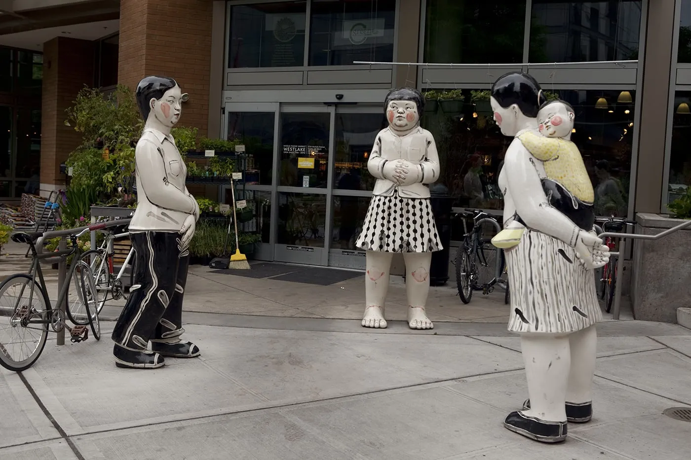 Young Woman, Girl, Mother and Child - a statue by Akio Takamori outside of a Whole Foods in Seattle, Washington.