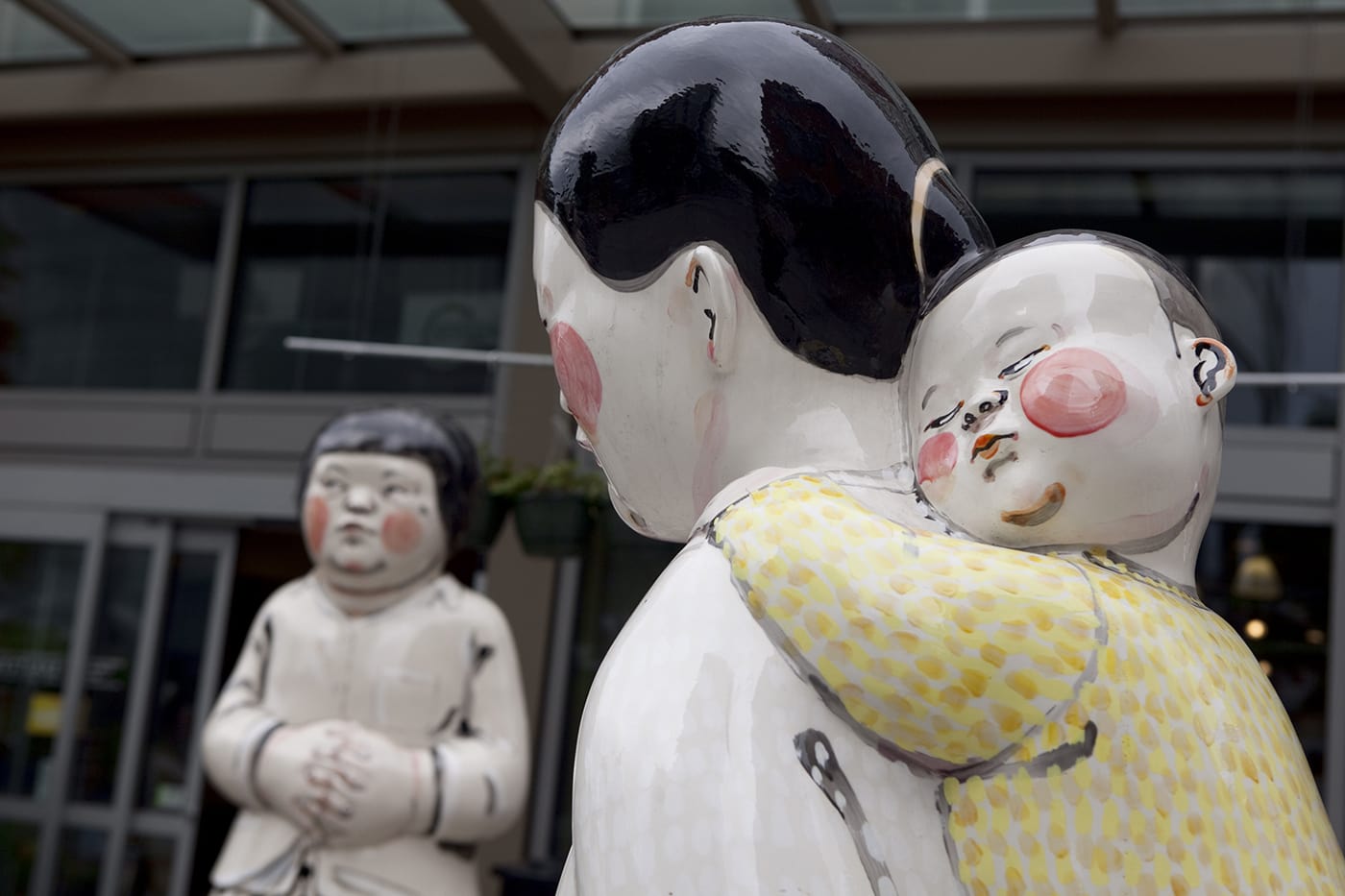 Young Woman, Girl, Mother and Child - a statue by Akio Takamori outside of a Whole Foods in Seattle, Washington.