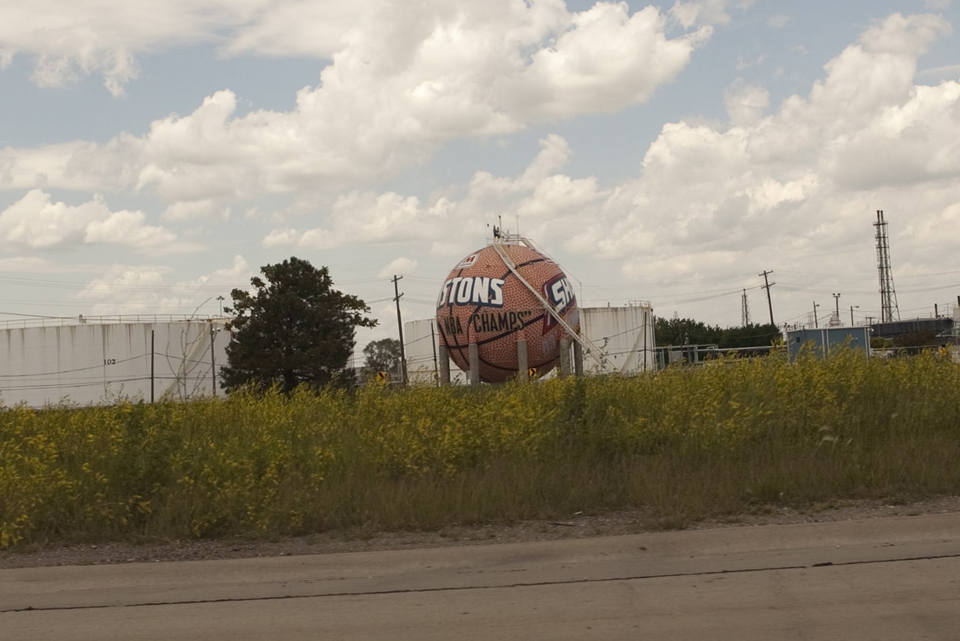 Giant basketball painted with the Detroit Pistons and WNBA Detroit Shock team logos, outside of Detroit, Michigan.