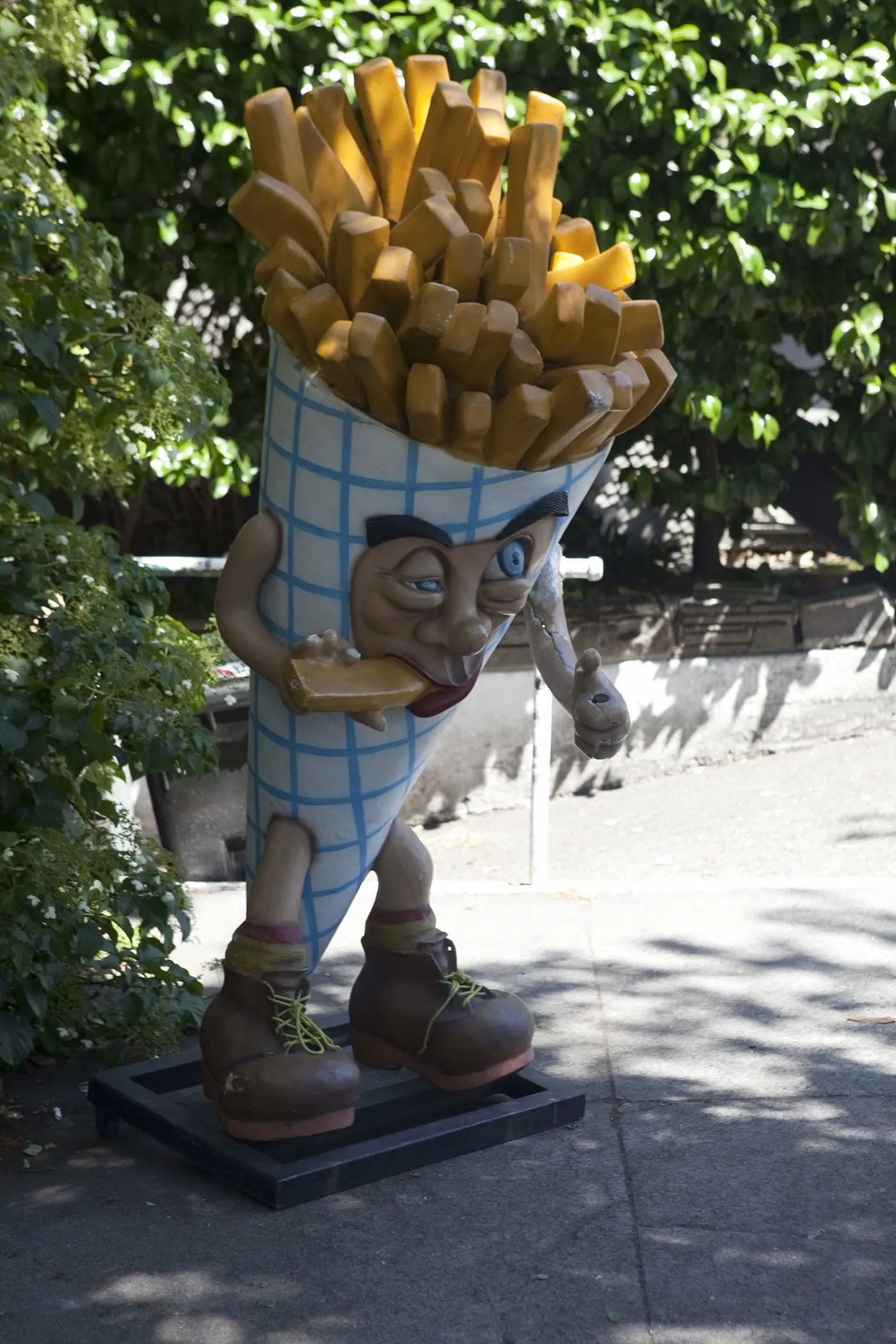 Deluxe Junk Fry Guy -  Giant cone of french fries eating a french fry outside of Deluxe Junk in Fremont, Seattle, Washington.