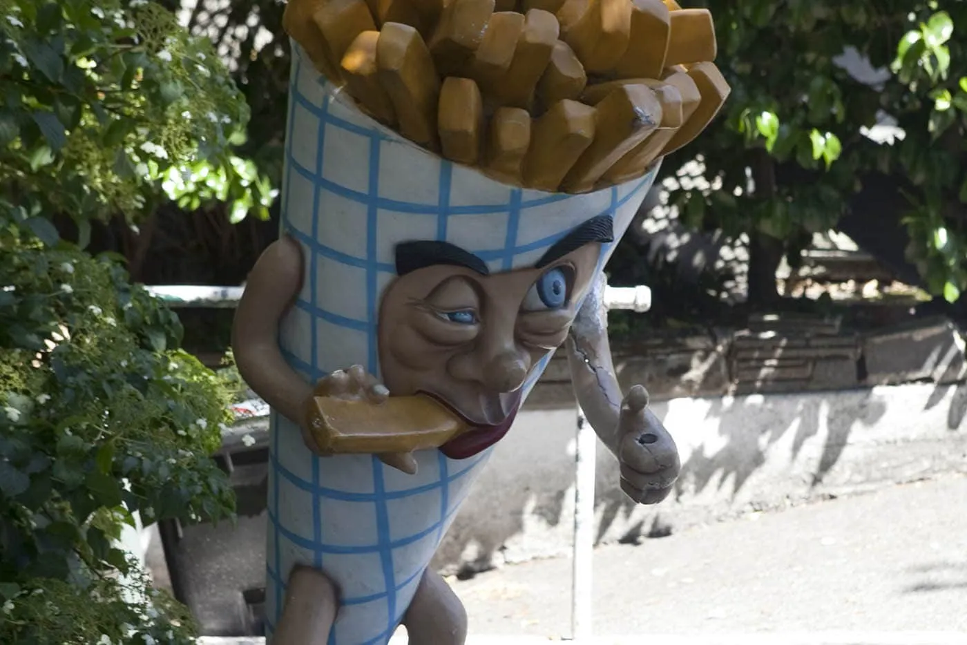 Deluxe Junk Fry Guy - Giant cone of french fries eating a french fry outside of Deluxe Junk in Fremont, Seattle, Washington.