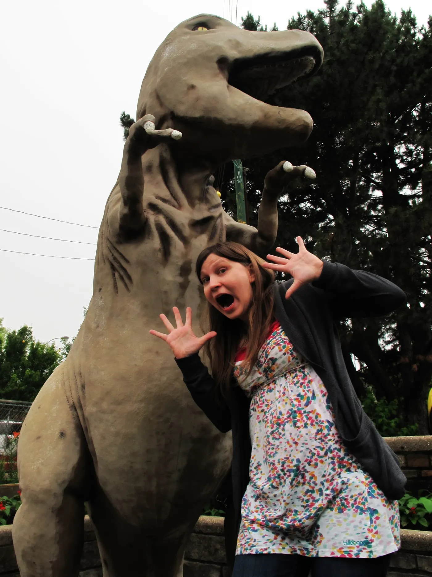 Val is scared of the dinosaur at Novelty Golf in Lincolnwood, Illinois.