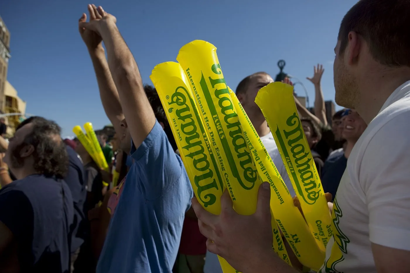 Fans hold thunder sticks at the Nathan's Famous hot dog eating contest at Coney Island.