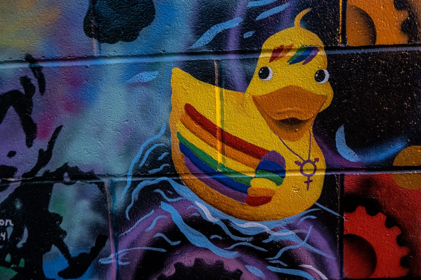 Detail of a rainbow-covered rubber duck. Alley 5.5: Bismarck Art Alley in North Dakota - Street art and Murals in Bismarck, North Dakota