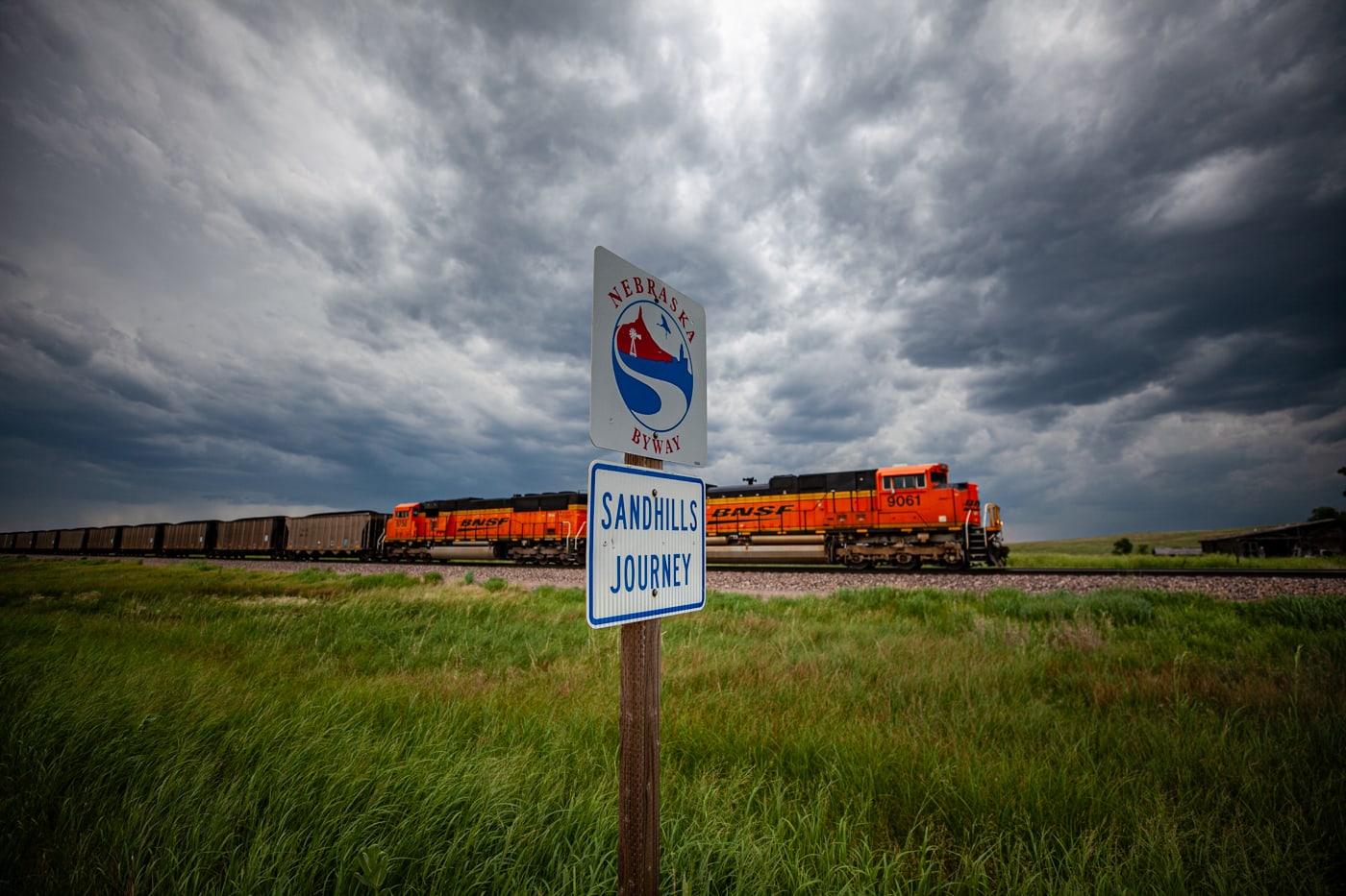 Nebraska Sandhills Journey Scenic Byway Road Sign with a train in the background