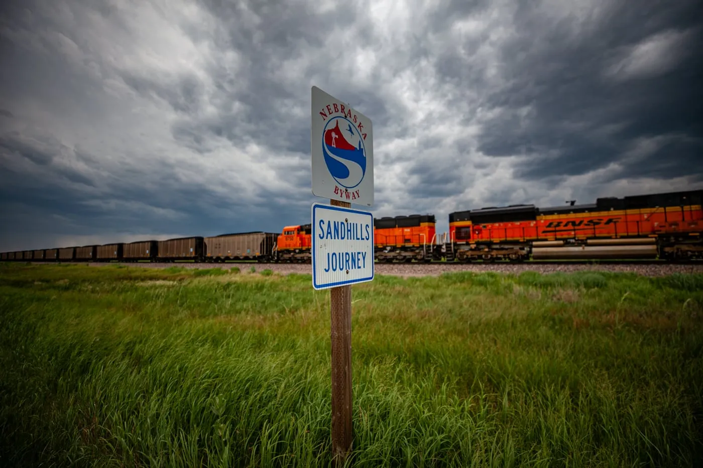 Nebraska Sandhills Journey Scenic Byway Road Sign with a train in the background