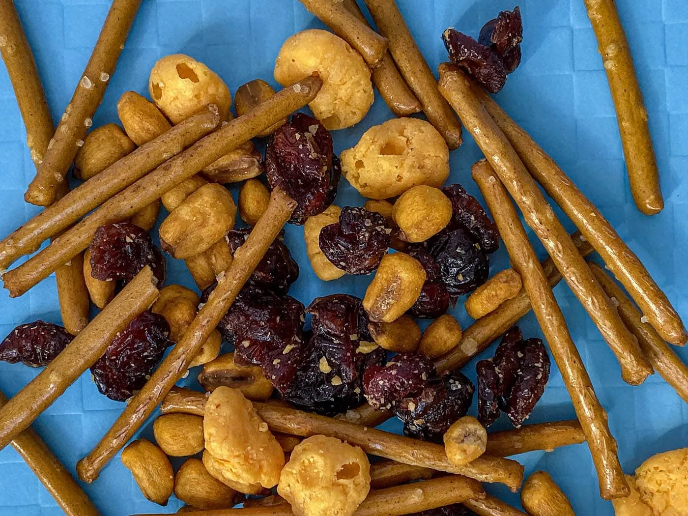 What are the best Wisconsin road trip snacks? We have them all plus the best Wisconsin recipe that snack mix combines all the flavors of the state. From cheese curds to pretzels to cranberries, this is what you should snack on in Wisconsin.
