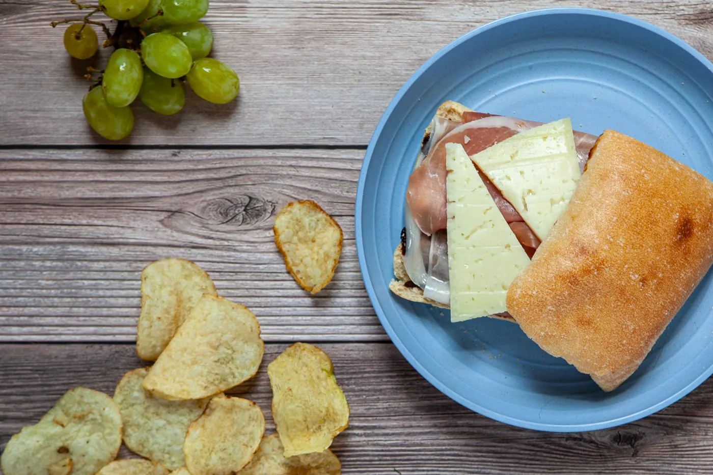 Road trip sandwiches - prosciutto, Manchego cheese, and fig jam sandwich on cheese sandwich on a ciabatta roll.
