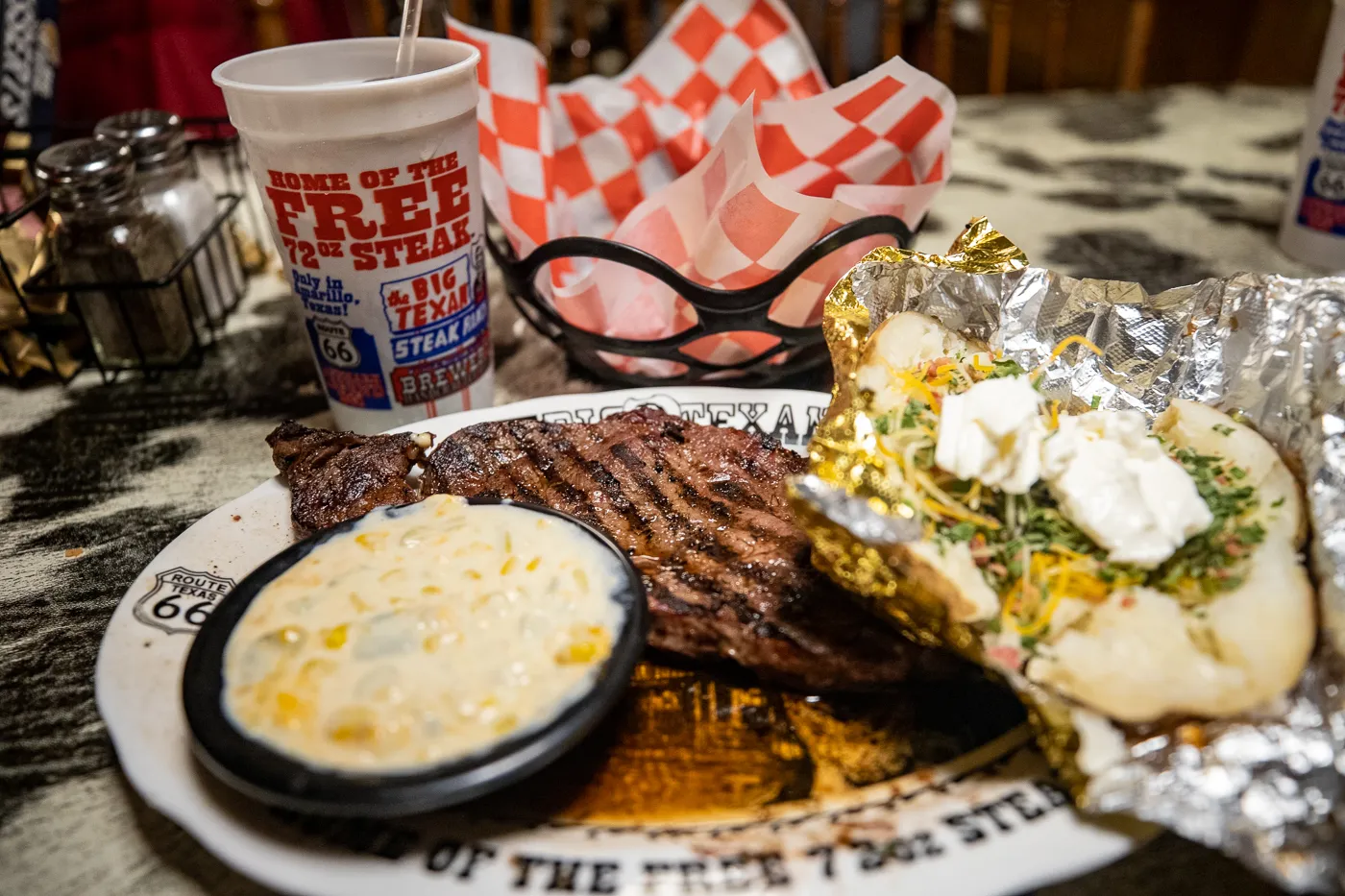 Steak dinner with a ribeye steak, loaded baked potato, and green chili creamed corn at The Big Texan Steak Ranch in Amarillo, Texas