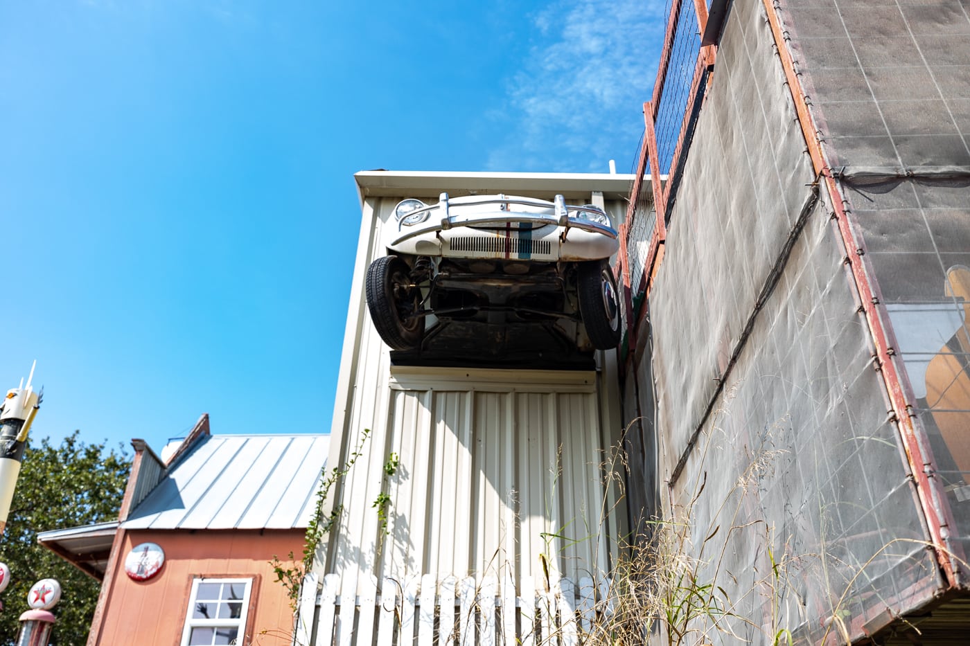 Car coming out of a building at OK County 66 - John's Place in Arcadia, Oklahoma - reproductions of famous Route 66 roadside attractions