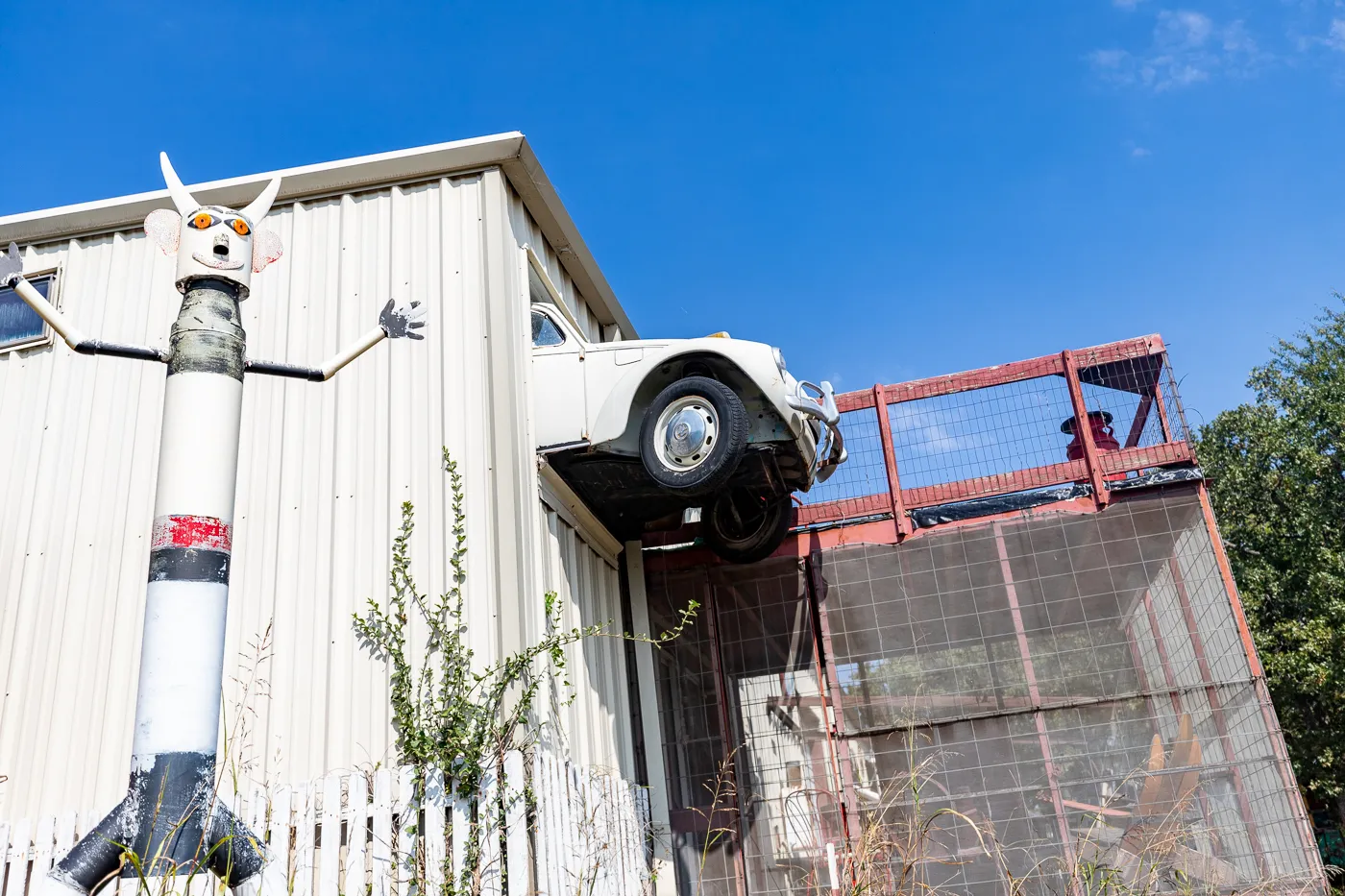 Car coming out of a building at OK County 66 - John's Place in Arcadia, Oklahoma - reproductions of famous Route 66 roadside attractions
