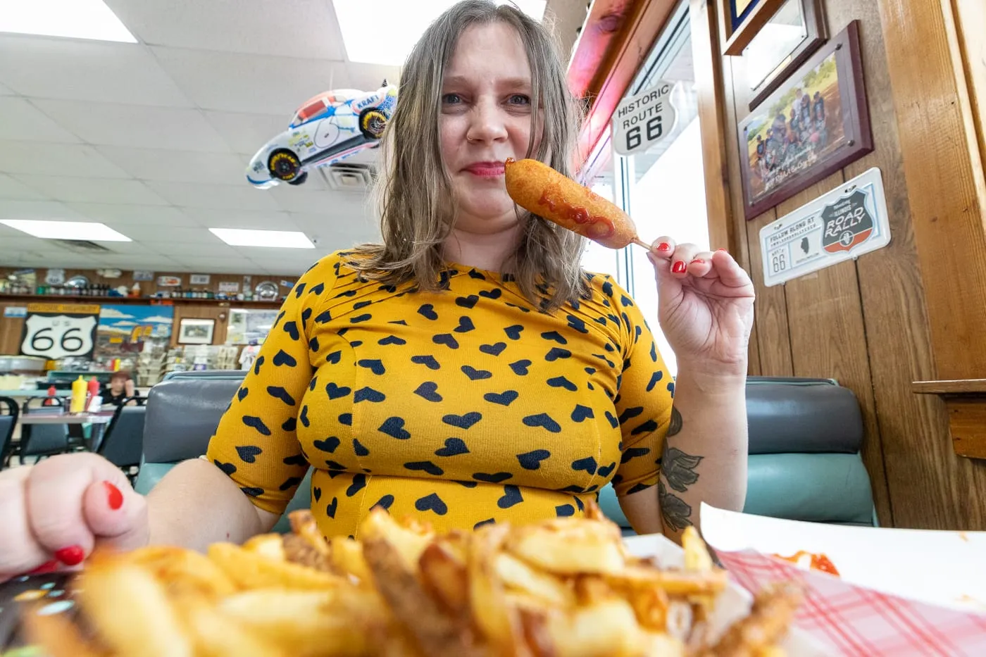 Eating a cozy dog corn dog at Cozy Dog Drive In in Springfield, Illinois on Route 66