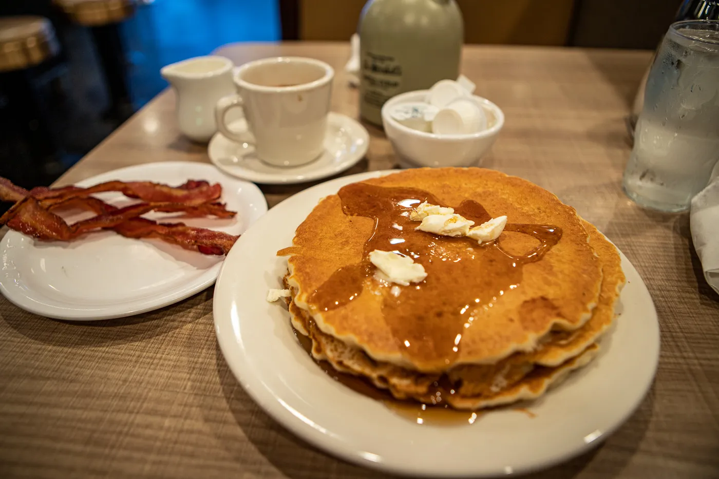 Pancakes with butter and maple syrup and a side of bacon at Lou Mitchell's Restaurant on Route 66 in Chicago, Illinois