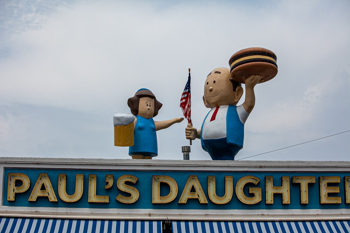 Paul's Daughter in Coney Island New York with an A&W Burger Family (A&W Root Beer Family) on the roof.