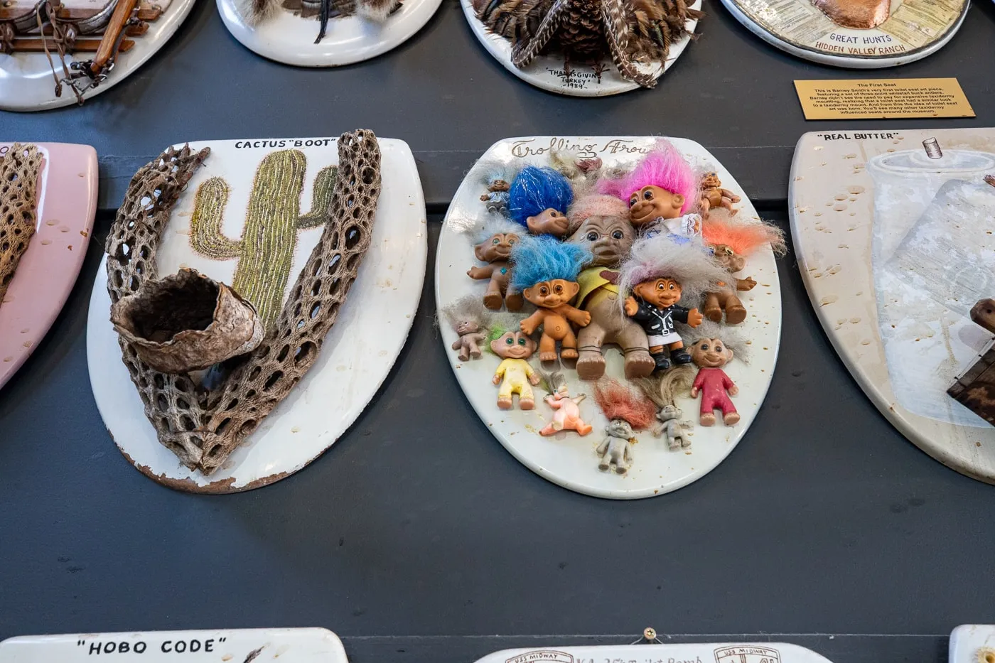 Troll doll toilet seat - Barney Smith's Toilet Seat Art Museum in The Colony, Texas at The Truck Yard Bar