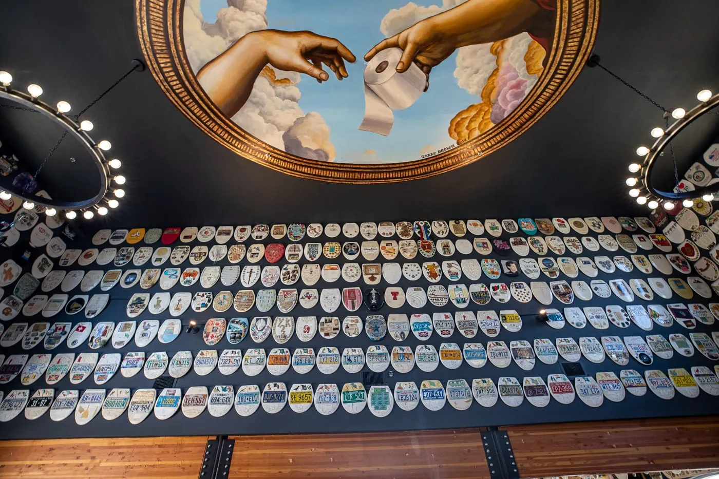 The Creation of Adam parody toilet paper roll mural on the ceiling of Barney Smith's Toilet Seat Art Museum in The Colony, Texas at The Truck Yard Bar