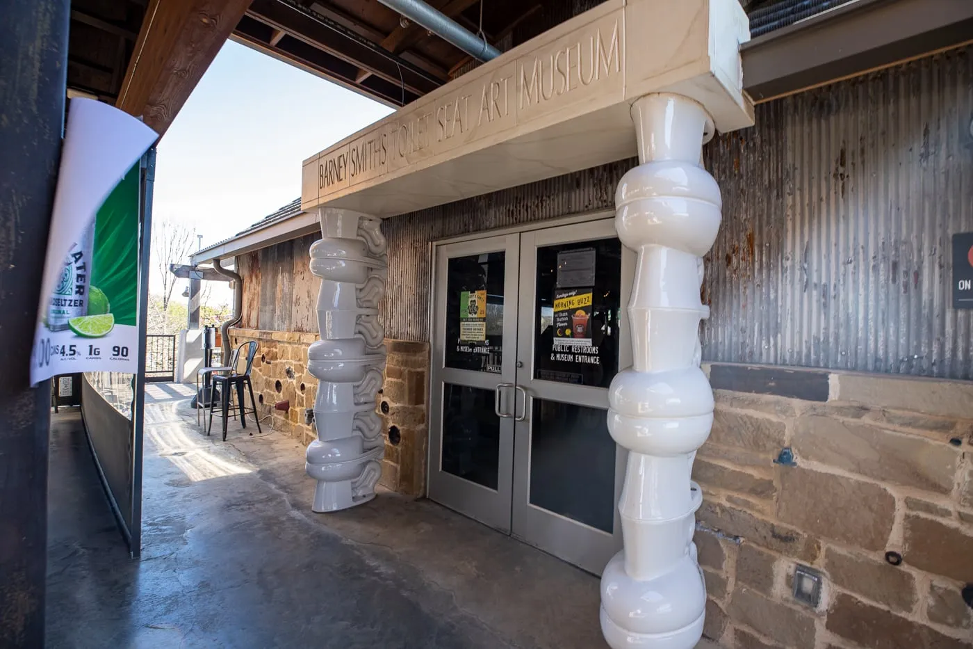 Stacked porcelain toilets at the Entrance to Barney Smith's Toilet Seat Art Museum in The Colony, Texas at The Truck Yard Bar