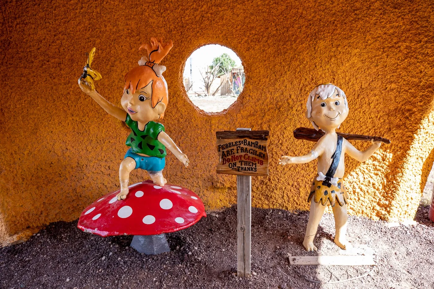 Pebbles and Bamm-Bamm Statues at Flintstones Bedrock City in Williams, Arizona - Arizona Roadside Attraction