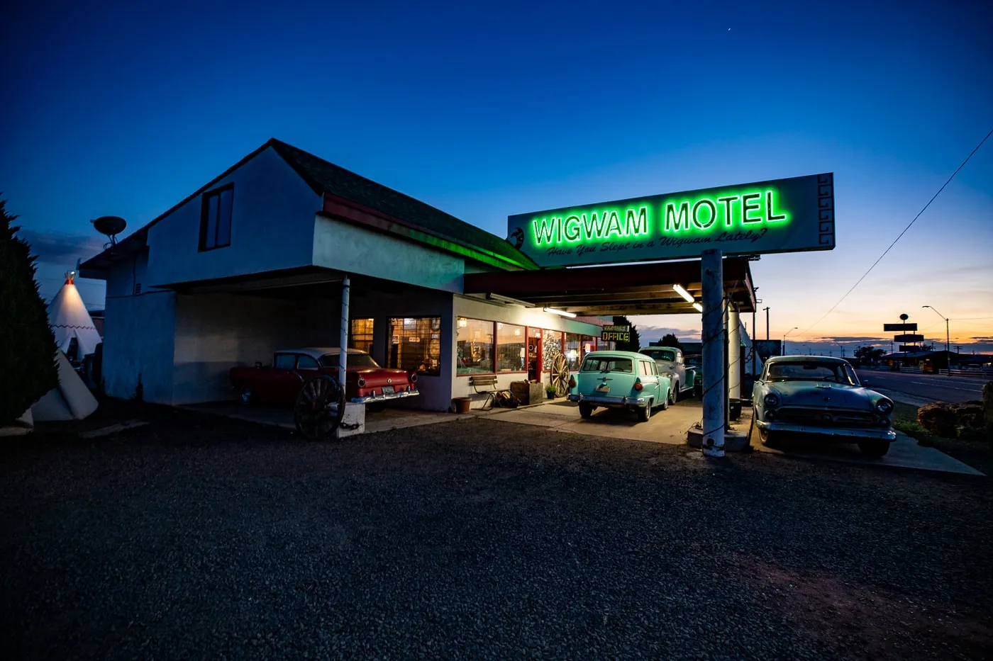 Reception building with lit up neon sign at Wigwam Motel in Holbrook, Arizona - Route 66 Motel - Wigwam Village Motel #6