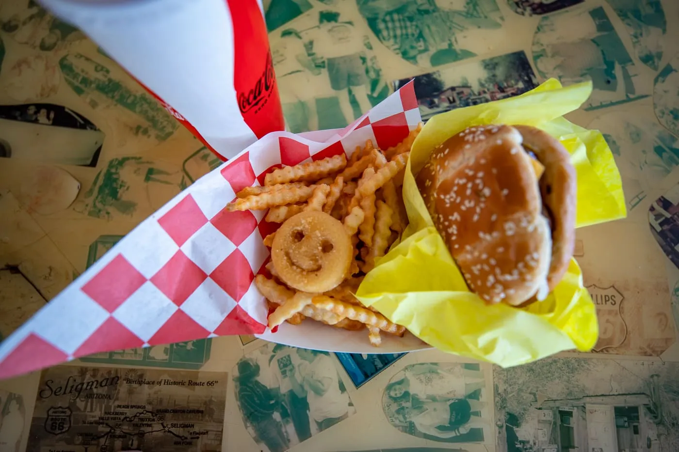 Cheeseburger with cheese, fries, a Smiles face fry, and a chocolate milkshake at Delgadillo’s Snow Cap in Seligman, Arizona - Route 66 restaurant and Drive-In Diner