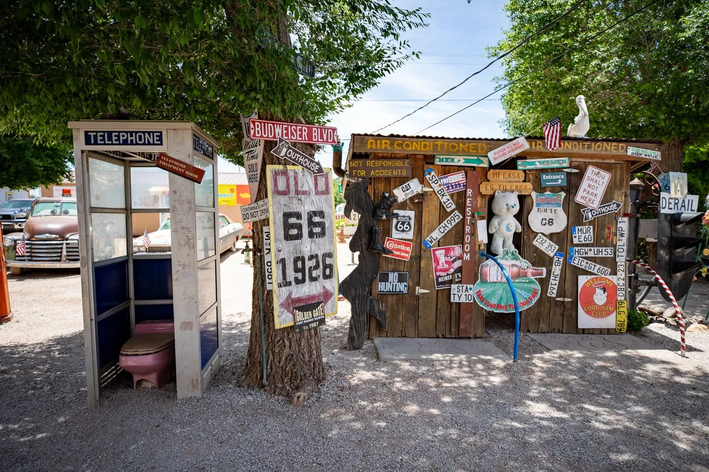 Outhouse and telephone booth at Delgadillo’s Snow Cap in Seligman, Arizona - Route 66 restaurant and Drive-In Diner