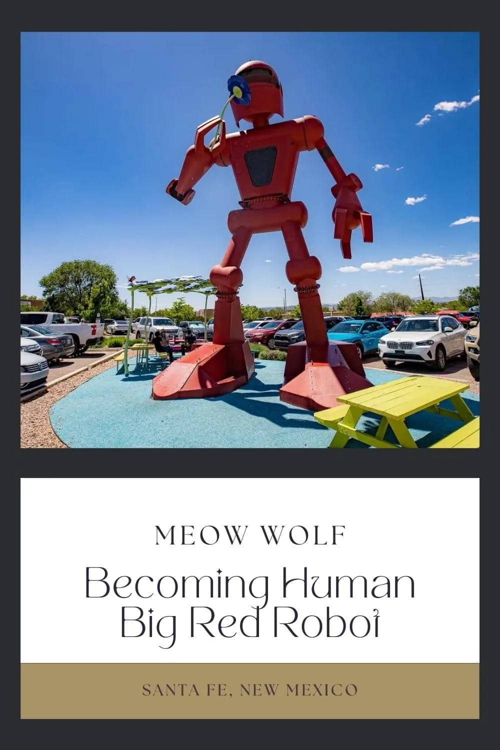 I love this roadside attraction a BOT! Find Becoming Human", the big red robot sculpture in front of Meow Wolf in Santa Fe, New Mexico. The big red robot in Meow Wolf's parking lot is officially titled "Becoming Human." The 30-foot tall art piece features a big robot smelling a big flower, and was designed by artist Christian Ristow. Find the roadside attraction at Meow Wolf Santa Fe House of Eternal Return. #MeowWolf #RoadsideAttraction #RoadsideAttractions #NewMexicoRoadsideAttraction