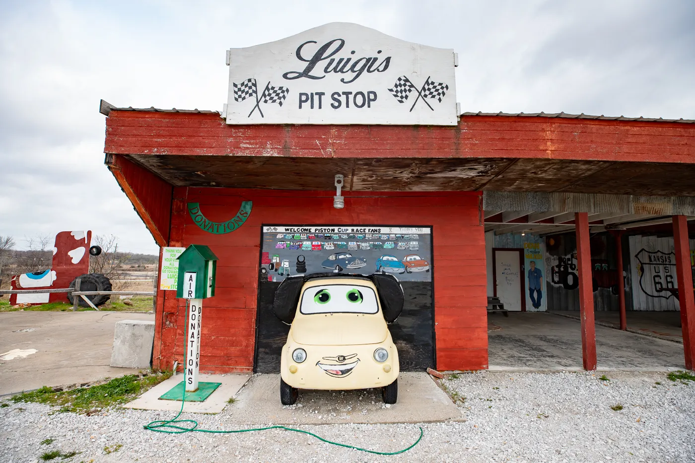 Yellow Fiat Luigi 3D mural from Cars at Luigi's Pit Stop in Galena, Kansas Route 66 Roadside Attraction and Cars movie attraction