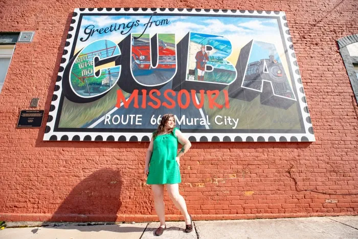 Greetings From Cuba. This life-sized postcard highlights unique landmarks, murals, and local industry in Cuba. Postcards were popular souvenirs along Route 66 during the peak of the Mother Road acclaim. October 2003.